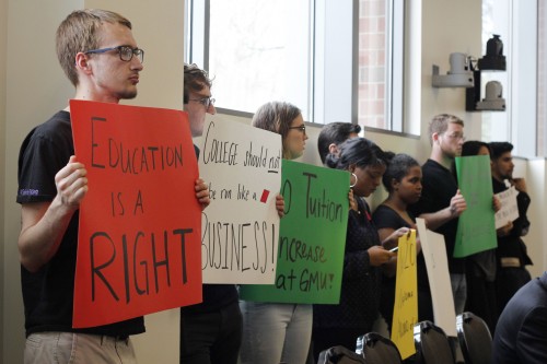 Members of GMU Student Power ask for a tuition freeze at the Board of Visitors meeting in Merten Hall on Thursday. (Amy Rose/Fourth Estate)