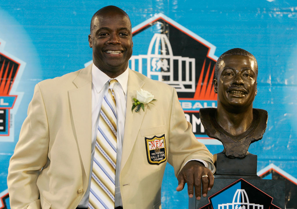 Darrell Green standing next to his bust in the Pro Football Hall of Fame during his induction. (Credit: Kiichiro Sato, AP)